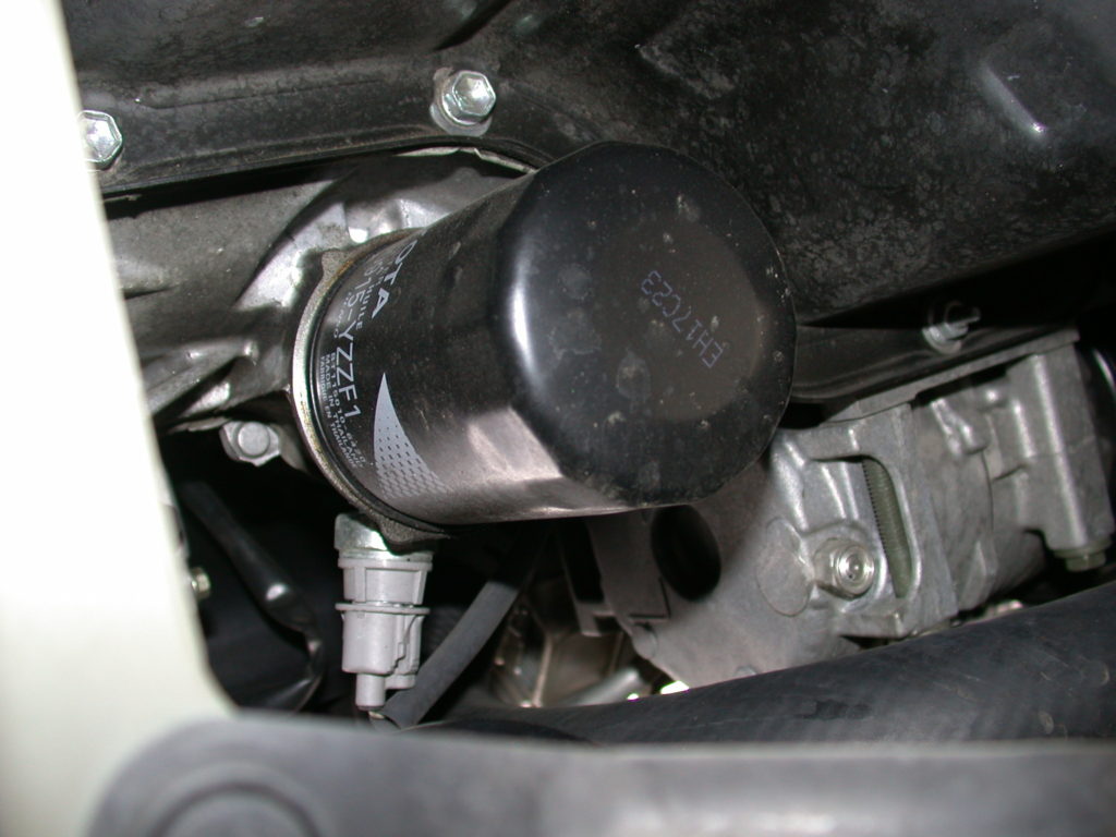 Oil filter installed on car engine.